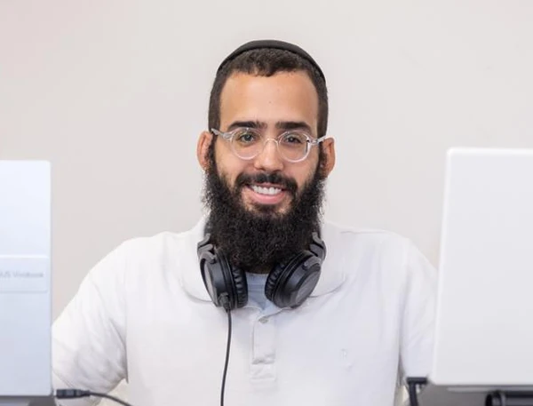 דיג׳י חיים עם אוזניות ליד עמדת הדיג׳יי